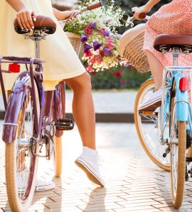 Back view of two girls in dresses sitting on a vintage bicycles blogimage